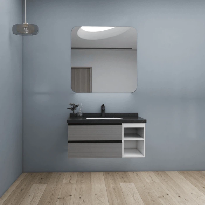 Small wall mounted vanity unit with black countertop and light grey drawers in minimalist bathroom interior. Small wall mounted vanity unit with black countertop and light grey drawers in minimalist bathroom interior.